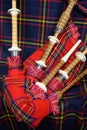 Scottish folk antique musical instrument bagpipes and colorful tartan fabric Royalty Free Stock Photo