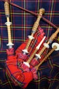 Scottish folk antique musical instrument bagpipes and colorful tartan fabric Royalty Free Stock Photo