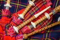 Scottish folk antique musical instrument bagpipes and colorful tartan fabric Royalty Free Stock Photo