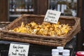 girolles in a wicker box that hangs on the wall, for sale on the market Royalty Free Stock Photo