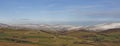 A Scottish Landscape of the Angus Glens looking towards Glen Esk, with snow on the tops of the Hills above the Farms.