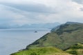 Scottish landscape with hills and shoreline near Staffin city at Isle of Skye with green pastures