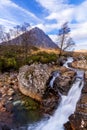 Scottish mountain with river waterfall and blue skies in winter Royalty Free Stock Photo