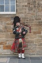 Scottish piper man dressing in Scottish traditional tartan kilt playing a bagpiper at Royal Mile in Edinburgh, Scotland, UK Royalty Free Stock Photo
