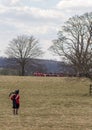 Scottish piper running to join Napoleonic battle reenactment Royalty Free Stock Photo