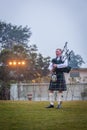 Scottish piper from Scotland in traditional outfit with tartan kilt playing bagpipe Royalty Free Stock Photo