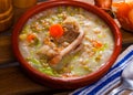 Scottish soup with lamb, vegetables, pulses, barley in clayware Royalty Free Stock Photo