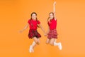 Scottish style. Cheerful friends schoolgirls jumping yellow background. Celebrate holiday. Scottish holiday. Join