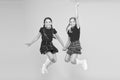 Scottish style. Cheerful friends schoolgirls jumping yellow background. Celebrate holiday. Scottish holiday. Join