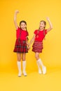 Scottish style. Kids girl wear checkered dresses. National holiday. School uniform. Cheerful friends schoolgirls jumping