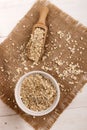 Scottish toasted oats in a bowl, wooden scoop and brown jute