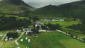 Scottish village aerial view: road in summer cloudy day. Cottages, distillery, camping in valley Royalty Free Stock Photo