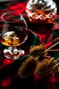 Scottish whiskey in a glass on tartan background