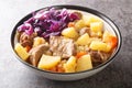 Scouse is a stew with meat and vegetables served with pickled cabbage close-up in a plate. Horizontal