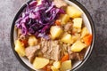 Scouse is a stew with meat and vegetables served with pickled cabbage close-up in a plate. Horizontal top view