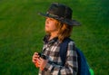 Scout boy wearing explorer hat and backpack outdoor. Explorer and adventure with binocular. Royalty Free Stock Photo