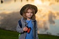 Scout boy wearing explorer hat and backpack outdoor. Explorer and adventure with binocular. Royalty Free Stock Photo