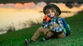 Scout boy wearing explorer hat and backpack outdoor. Explorer and adventure with binocular. Royalty Free Stock Photo