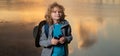 Scout boy wearing explorer hat and backpack outdoor. Explorer and adventure with binocular. Royalty Free Stock Photo