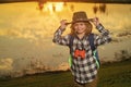 Scout boy wearing explorer hat and backpack outdoor. Explorer and adventure with binocular. Royalty Free Stock Photo