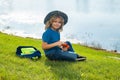 Scout boy wearing explorer hat and backpack outdoor. Explorer and adventure with binocular. Royalty Free Stock Photo