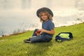 Scout boy wearing explorer hat and backpack outdoor. Explorer and adventure with binocular. Royalty Free Stock Photo