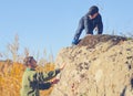 Scout helping a young boy rock climbing Royalty Free Stock Photo