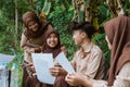 Scout youths chat and do clipboard assignments together