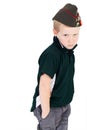 Scowling young blonde boy wearing green shirt and Russian Vintage army hat - pilotka