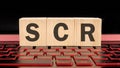 scr written on wooden cubes on the laptop keyboard
