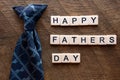 Happy fathers day with a blue tie and scrable letters Royalty Free Stock Photo