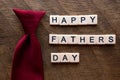 Happy fathers day with a red tie and scrable letters