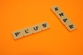 Scrabble tiles arranged PLUS & ANPR on cross manner in orange background Royalty Free Stock Photo