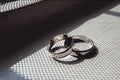 Scrached wedding rings of white gold on a window sill