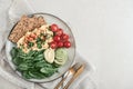 Scramble eggs with cherry tomatoes, fresh spinach leaves, avocado and crispbreads