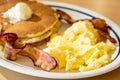 Scramble eggs, hot cakes and bacon Royalty Free Stock Photo