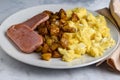 scramble eggs with homefries served with spam