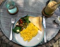 Scrambled egg breakfast with grilled vegetables, toast, and iced