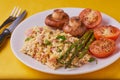 Healthy fried breakfast on yellow background.