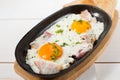 Scrambled eggs with bacon and fresh herbs fried in a pan. Served with bread toast Royalty Free Stock Photo