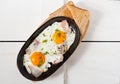 Scrambled eggs with bacon and fresh herbs fried in a pan. Served with bread toast Royalty Free Stock Photo