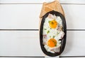 Scrambled eggs with bacon and fresh herbs fried in a pan. Served with bread toast Royalty Free Stock Photo