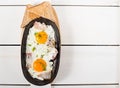 Scrambled eggs with bacon and fresh herbs fried in a pan. Served with bread toast Royalty Free Stock Photo