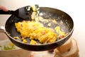 Scrambled eggs and bacon in metal black cooking pan Italian Food Royalty Free Stock Photo