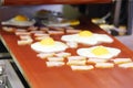 Scrambled eggs and bacon roasted and go along conveyor Royalty Free Stock Photo