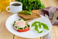 Scrambled eggs, baked in a ring bell pepper, toast, arugula leaves and a cup of coffee Royalty Free Stock Photo