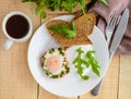 Scrambled eggs, baked in a ring bell pepper, toast, arugula leaves and a cup of coffee. Royalty Free Stock Photo