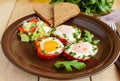 Scrambled eggs baked in a ring bell pepper, toast, arugula leaves and a light salad with cabbage, bell pepper, cucumber. Royalty Free Stock Photo