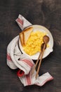 Scrambled eggs for breakfast on red old frying pan, dark wooden table background. Traditional English breakfast. Top view with Royalty Free Stock Photo
