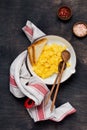 Scrambled eggs for breakfast on red old frying pan, dark wooden table background. Traditional English breakfast. Top view with Royalty Free Stock Photo